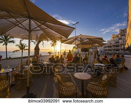 Stock Image - "Beach promenade with restaurants in the evening, Puerto De Naos, La Palma, Canary Islands, Spain, Europe". Fotosearch