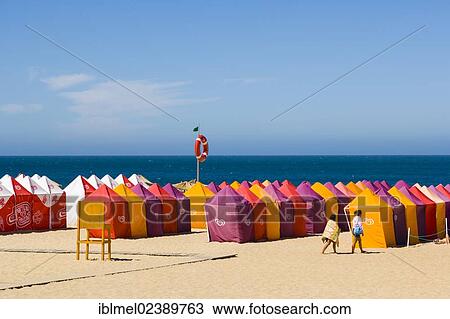 Stock Image - "Beach with beach tents, Praia da Nazare, Nazare, Oeste, Leiria District, Portugal, Europe". Fotosearch