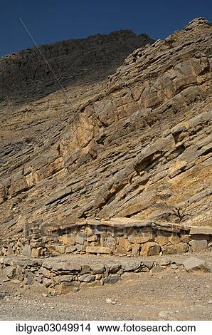 "Bedouin stone house matching in colour and texture to the foot of a cliff in the mountains of Musandam, Musandam Governorate, Oman, Asia" View Large Photo Image Picture - "Bedouin stone house matching in colour and texture to the foot of a cliff in the mountains of Musandam, Musandam Governorate, Oman, Asia". Fotosearch