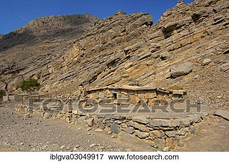 "Bedouin stone house matching in colour and texture to the foot of a cliff in the mountains of Musandam, Musandam Governorate, Oman, Asia" View Large Photo Image Stock Photo - "Bedouin stone house matching in colour and texture to the foot of a cliff in the mountains of Musandam, Musandam Governorate, Oman, Asia". Fotosearch