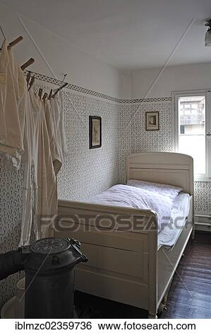 "Bedroom of the early 20th century with a bed, a potbelly stove and a laundry line on the left, industrial museum, Lauf, Middle Franconia, Bavaria, Germany, Europe" View Large Photo Image Stock Photograph - "Bedroom of the early 20th century with a bed, a potbelly stove and a laundry line on the left, industrial museum, Lauf, Middle Franconia, Bavaria, Germany, Europe". Fotosearch