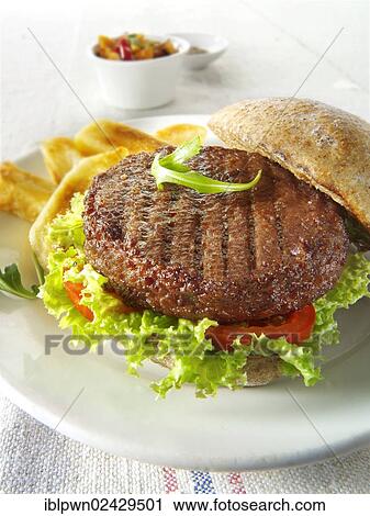 Beef burger in a wholemeal bun with salad and french fries View Large Photo Image Stock Image - Beef burger in a wholemeal bun with salad and french fries. Fotosearch