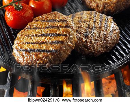 Stock Photo - Beef burgers being cooked. Fotosearch