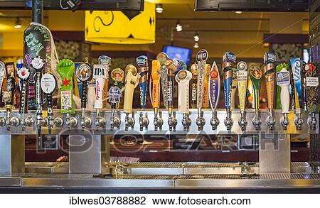 Stock Image - "Beer on tap at Bar Louie at the Holiday Inn O'Hare, Chicago, Illinois, United States, North America". Fotosearch