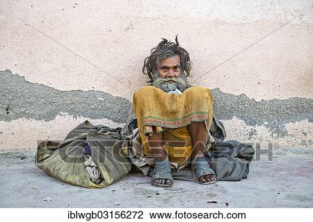 "Beggar leaning against a house wall, sitting down, Orchha, Madhya Pradesh, India, Asia" View Large Photo Image Stock Image - "Beggar leaning against a house wall, sitting down, Orchha, Madhya Pradesh, India, Asia". Fotosearch