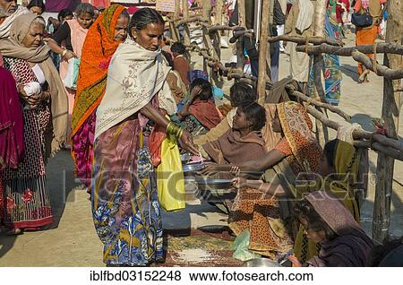 Stock Photo - "Beggars sitting in a row, begging, during Kumbha Mela, Allahabad, Uttar Pradesh, India, Asia". Fotosearch