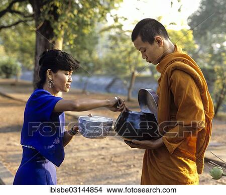 "Begging monk, woman putting rice into the begging bowl of a Buddhist monk, Mae Hong Son, Northern Thailand, Thailand, Asia" View Large Photo Image Picture - "Begging monk, woman putting rice into the begging bowl of a Buddhist monk, Mae Hong Son, Northern Thailand, Thailand, Asia". Fotosearch