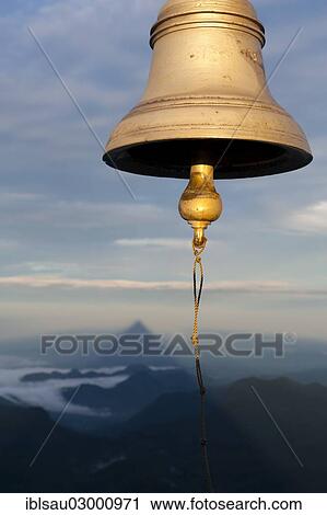 Stock Image - "Bell, the shadow of the mountain at the back, the image of God, holy mountain, buddhist temple, Adam's Peak, Sri Pada, Dalhousie, Zentrales Hochland, Sri Lanka, Asia". Fotosearch