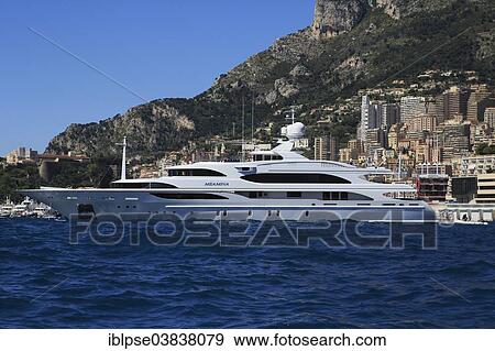 Benetti motor yacht Meamina at anchor in front of the Principality of Monaco View Large Photo Image Stock Photo - Benetti motor yacht Meamina at anchor in front of the Principality of Monaco. Fotosearch