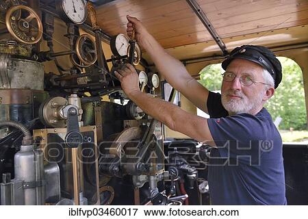 "Bernd Roschach, train driver chairman of the Acher Valley Railway Society, standing in a locomotive of the Acher Valley Railway from 1928 in Ottenhoefen station, Ottenhofen im Schwarzwald, Black Forest, Baden-Wurttemberg, Germany, Europe" View Large Photo Image Stock Photo - "Bernd Roschach, train driver chairman of the Acher Valley Railway Society, standing in a locomotive of the Acher Valley Railway from 1928 in Ottenhoefen station, Ottenhofen im Schwarzwald, Black Forest, Baden-Wurttemberg, Germany, Europe". Fotosearch
