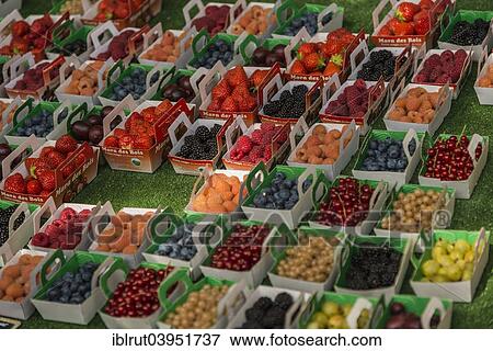Stock Photo - "Berries in punnets on sale at a farmers' market in Provence, Lourmarin, Apt, Vaucluse, Provence-Alpes-Cote d'Azur, France, Europe". Fotosearch
