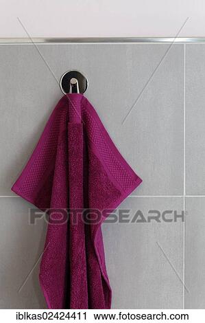 Berry-colored towel hanging on a hook, tiled wall, bathroom View Large Photo Image Stock Image - Berry-colored towel hanging on a hook, tiled wall, bathroom. Fotosearch