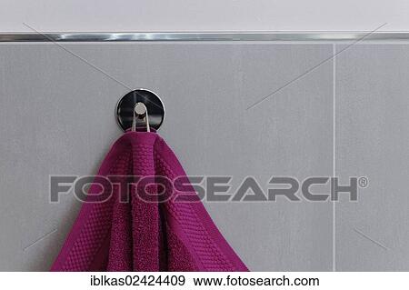 Berry-colored towel hanging on a hook, tiled wall, bathroom View Large Photo Image Stock Photo - Berry-colored towel hanging on a hook, tiled wall, bathroom. Fotosearch