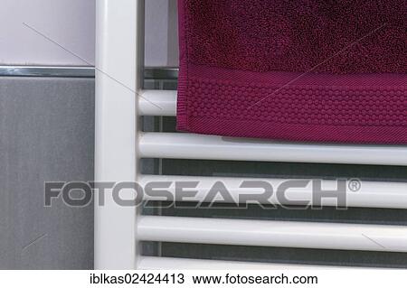 Berry-colored towel hanging on a radiator to dry, bathroom View Large Photo Image Stock Image - Berry-colored towel hanging on a radiator to dry, bathroom. Fotosearch