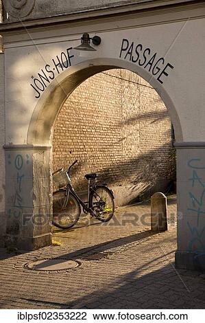 "Bicycle at the gateway to Joens Hof Passage in the evening light, Kappeln, Schleswig-Holstein, Germany, Europe" View Large Photo Image Stock Image - "Bicycle at the gateway to Joens Hof Passage in the evening light, Kappeln, Schleswig-Holstein, Germany, Europe". Fotosearch