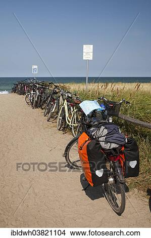 Picture - "Bicycles at the entrance to the beach, Baltic Sea peninsula of Fischland-Darss-Zingst, Baltic Sea resort of Zingst, Mecklenburg-Vorpommern, Germany, Europe". Fotosearch