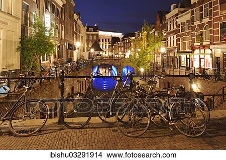 Picture - "Bicycles in the historic town centre at night on Oudegracht canal, Utrecht, Province of Utrecht, The Netherlands, Europe". Fotosearch