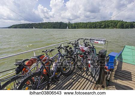 "Bicycles on a ferry on a Masurian Lake, near Mikolajki, Warmian-Masurian Voivodeship, Poland, Europe" View Large Photo Image Stock Image - "Bicycles on a ferry on a Masurian Lake, near Mikolajki, Warmian-Masurian Voivodeship, Poland, Europe". Fotosearch