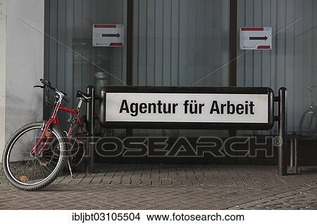 Picture - "Bicycles parked beside the sign """"Agentur fuer Arbeit"""", German for Employment Agency, Cologne, Rhineland, North Rhine-Westphalia, Germany, Europe". Fotosearch