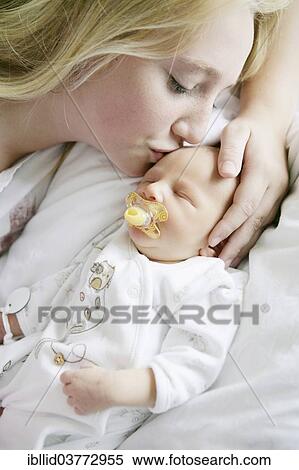 Big sister kissing her newborn brother View Large Photo Image Stock Photography - Big sister kissing her newborn brother. Fotosearch