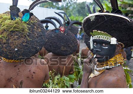 "Black decorated and painted tribesmen celebrating the traditional Sing Sing in the highlands, Enga, Highlands, Papua New Guinea, Oceania" View Large Photo Image Stock Photo - "Black decorated and painted tribesmen celebrating the traditional Sing Sing in the highlands, Enga, Highlands, Papua New Guinea, Oceania". Fotosearch