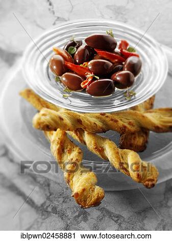 Black olives and cheese straws View Large Photo Image Stock Image - Black olives and cheese straws. Fotosearch