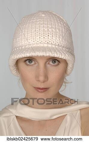 Stock Photo - "Blond woman with a white woolly hat, portrait". Fotosearch