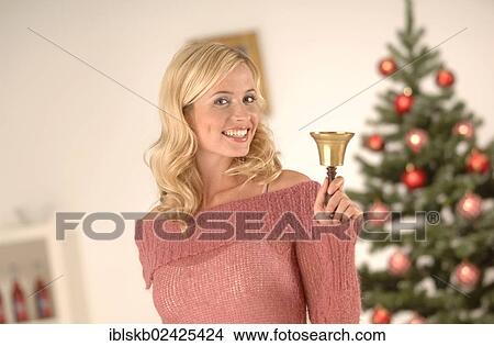"Blonde woman, 20-30, ringing a golden bell, Christmas ambience" View Large Photo Image Picture - "Blonde woman, 20-30, ringing a golden bell, Christmas ambience". Fotosearch