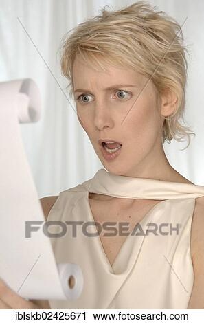 Blonde woman reading from a paper roll View Large Photo Image Stock Image - Blonde woman reading from a paper roll. Fotosearch