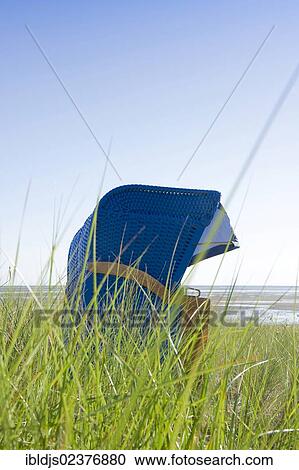 Stock Image - "Blue beach chair on the beach of Wyk, Foehr island, North Frisia, Schleswig-Holstein, Germany, Europe". Fotosearch