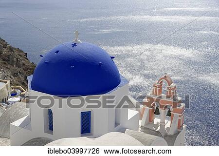 Stock Photograph - "Blue dome of a Byzantine Orthodox Church with a bell tower, Caldera, Oia, Santorini, Cyclades, Greece, Europe". Fotosearch
