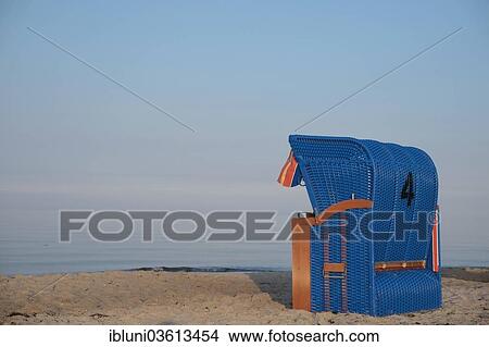 "Blue roofed wicker beach chair on a beach, Maasholm, Schleswig-Holstein, Germany, Europe" View Large Photo Image Picture - "Blue roofed wicker beach chair on a beach, Maasholm, Schleswig-Holstein, Germany, Europe". Fotosearch