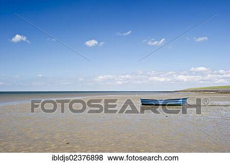 Stock Photo - "Blue rowing boat on the beach of Utersum, Foehr island, North Frisia, Schleswig-Holstein, Germany, Europe". Fotosearch