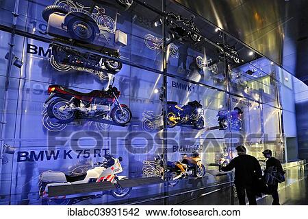 Stock Image - "BMW motorcycles behind glass wall, BMW Museum, Munich, Upper Bavaria, Bavaria, Germany, Europe". Fotosearch