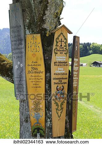 Stock Image - "Boards commemorating the dead near the Parish Church of St George, Ruhpolding, Chiemgau, Upper Bavaria, Bavaria, Germany, Europe, PublicGround, Europe". Fotosearch
