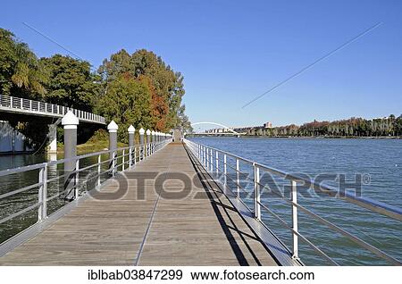 "Boardwalk, promenade on the Guadalquivir river, Puente de la Barqueta bridge at the back, Seville, Andalusia, Spain, Europe" View Large Photo Image Stock Photo - "Boardwalk, promenade on the Guadalquivir river, Puente de la Barqueta bridge at the back, Seville, Andalusia, Spain, Europe". Fotosearch