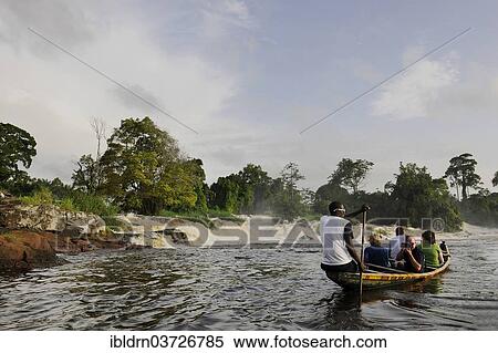 Stock Photography - "Boat in front of the cascades where the Lobe River plunges over 30 meters into the Atlantic, Kribi, South Region, Cameroon, Africa". Fotosearch