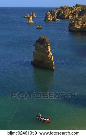 "Boat off the cliffs at Praia da Dona Ana beach, Lagos, Algarve, Portugal, Europe" View Large Photo Image Stock Photo - "Boat off the cliffs at Praia da Dona Ana beach, Lagos, Algarve, Portugal, Europe". Fotosearch