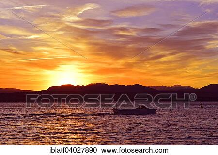 "Boat on Lake Garda, Lago di Garda, with sunset, Desenzano del Garda at the back, Sirmione, Lombardy, Italy, Europe" View Large Photo Image Stock Image - "Boat on Lake Garda, Lago di Garda, with sunset, Desenzano del Garda at the back, Sirmione, Lombardy, Italy, Europe". Fotosearch