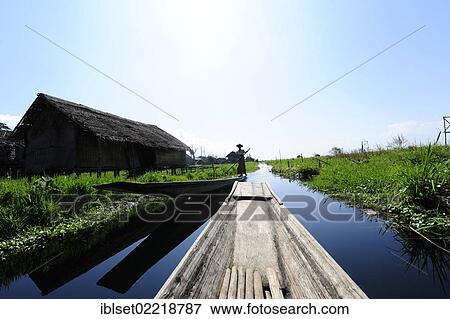 Stock Photo - "Boat ride through a floating village on Inle Lake, Burma also known as Myanmar, Southeast Asia, Asia". Fotosearch