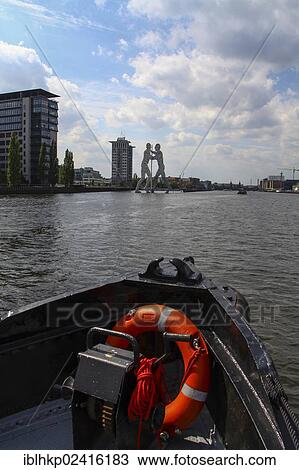 Boat with lifesaver on the Spree river, behind the Molecule Man sculpture, Berlin, Germany, Europe View Large Photo Image Stock Image - Boat with lifesaver on the Spree river, behind the Molecule Man sculpture, Berlin, Germany, Europe. Fotosearch