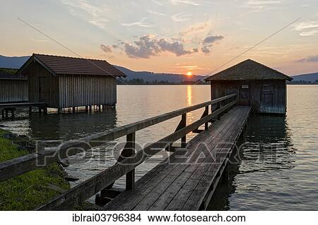 "Boathouses at sunset on Lake Kochel, in Kochel am See, Upper Bavaria, Bavaria, Germany, Europe" View Large Photo Image Picture - "Boathouses at sunset on Lake Kochel, in Kochel am See, Upper Bavaria, Bavaria, Germany, Europe". Fotosearch