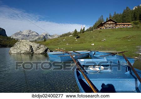 Stock Photo - "Boats and an inn, Oeschinensee lake, Kandersteg, Bernese Oberland, Canton of Bern, Switzerland, Europe". Fotosearch