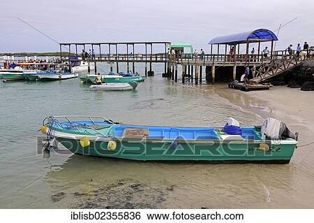 Stock Photograph - "Boats and jetty in the harbour of Puerto Villamil, Isabela Island, Galapagos Islands, UNESCO World Heritage Site, Ecuador, South America". Fotosearch