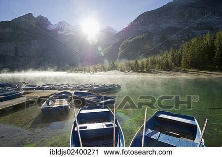 "Boats and morning fog, Oeschinensee lake, Kandersteg, Bernese Oberland, Canton of Bern, Switzerland, Europe" View Large Photo Image Stock Image - "Boats and morning fog, Oeschinensee lake, Kandersteg, Bernese Oberland, Canton of Bern, Switzerland, Europe". Fotosearch