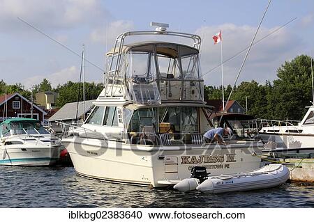 Stock Image - "Boats at dock, Bras d'Or Lake, Baddeck, Cape Breton, Nova Scotia, Canada, North America". Fotosearch