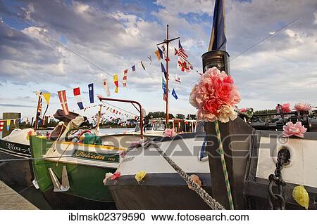 Stock Image - "Boats decorated for the 42nd Pardon de marines, pilgrimage of the boatmen on the Saone and its banks, Saint-Jean-de-Losne, Dijon, Burgundy, Cote d'Or department, France, Europe". Fotosearch