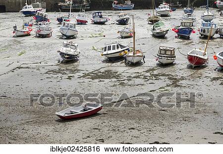 "Boats in the harbour of Porthleven at low tide, Cornwall, England, United Kingdom, Europe" View Large Photo Image Stock Photograph - "Boats in the harbour of Porthleven at low tide, Cornwall, England, United Kingdom, Europe". Fotosearch