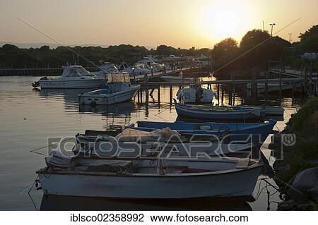 Stock Image - "Boats in the port at sunset, Ognina, Siracusa, Syracuse, Sicily, Italy, Europe". Fotosearch