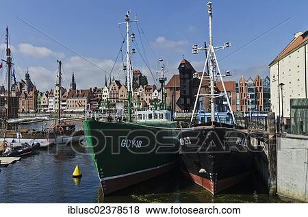 "Boats moored in front of a row of houses of Long Bridge with Krantor, Crane Gate, Gdansk, Poland, Europe" View Large Photo Image Stock Photo - "Boats moored in front of a row of houses of Long Bridge with Krantor, Crane Gate, Gdansk, Poland, Europe". Fotosearch